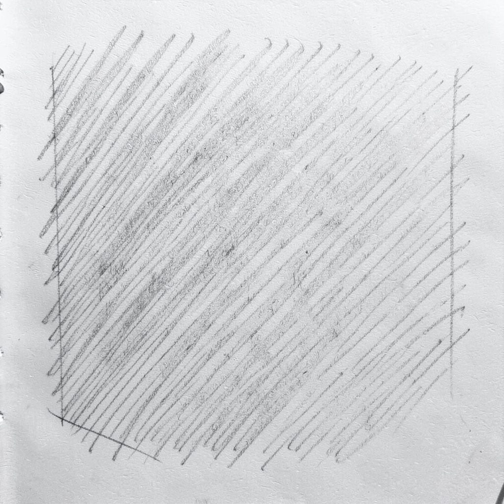 Pencil sketch of a royal blue t-shirt folded neatly on a flat surface, drawn with soft graphite shading